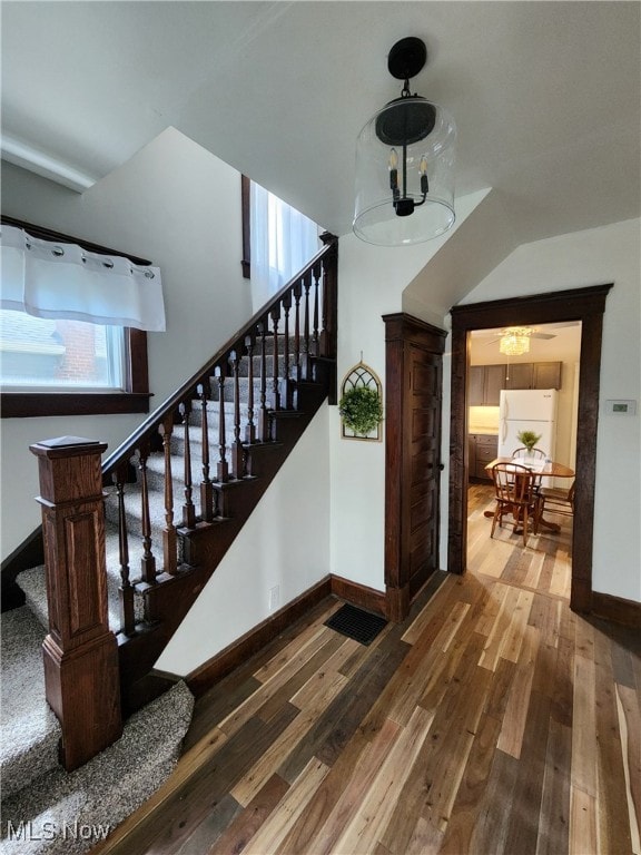 600 Orchard Ave, Cambridge, OH 43725 - stairs featuring wood-type flooring and a chandelier