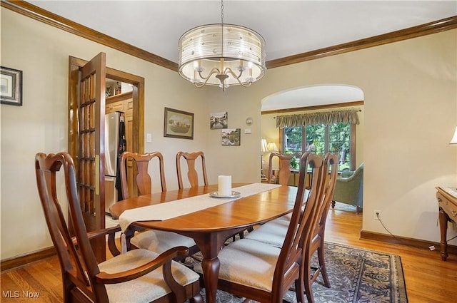 2925 Millboro Rd, Silver Lake, OH 44224 - dining room featuring crown molding, light wood-style floors, and a chandelier