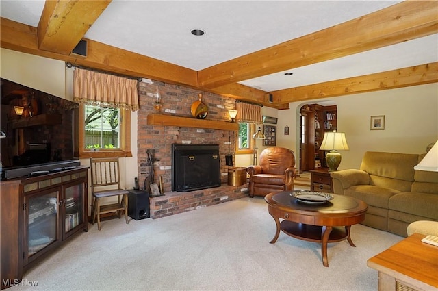2925 Millboro Rd, Silver Lake, OH 44224 - living room with healthy amount of natural light, beam ceiling, a brick fireplace, carpet flooring, and arched walkways