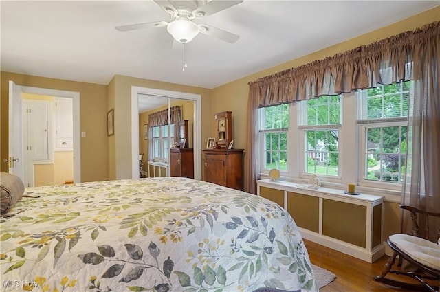 2925 Millboro Rd, Silver Lake, OH 44224 - bedroom featuring multiple windows, wood finished floors, a closet, and a ceiling fan
