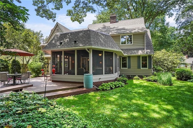 2925 Millboro Rd, Silver Lake, OH 44224 - rear view of property featuring a shingled roof, a sunroom, a deck, and a lawn