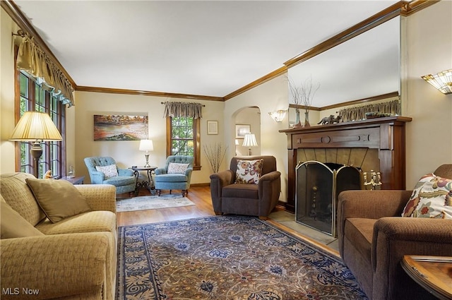 2925 Millboro Rd, Silver Lake, OH 44224 - living area featuring arched walkways, a fireplace, wood finished floors, and ornamental molding