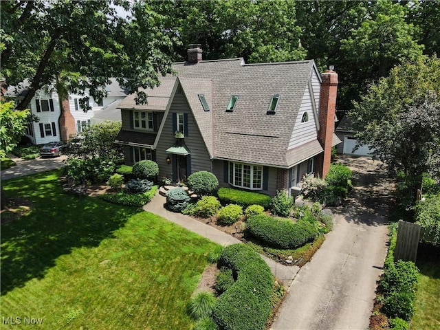 2925 Millboro Rd, Silver Lake, OH 44224 - view of front of house with roof with shingles, a front lawn, a chimney, and driveway