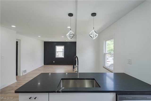 12800 Reindeer Ave, Garfield Heights, OH 44125 - kitchen with dark countertops, stainless steel dishwasher, open floor plan, white cabinetry, and recessed lighting