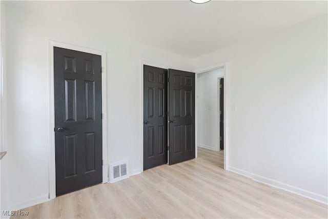12800 Reindeer Ave, Garfield Heights, OH 44125 - unfurnished bedroom featuring light wood finished floors and a closet