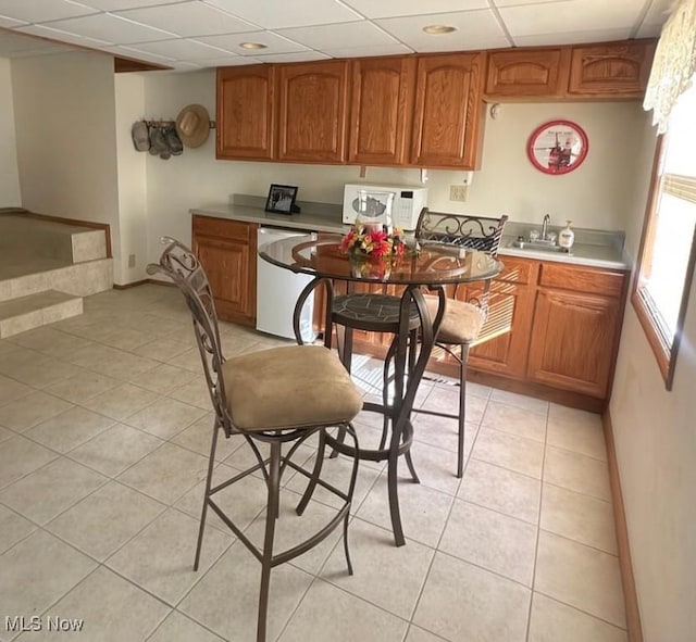 1321 Congo Arroyo Rd, New Cumberland, WV 26047 - kitchen featuring white microwave, fridge, light tile patterned flooring, brown cabinets, and light countertops