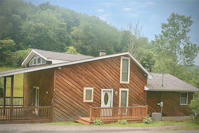1321 Congo Arroyo Rd, New Cumberland, WV 26047 - view of home's exterior with a wooden deck, a chimney, and roof with shingles