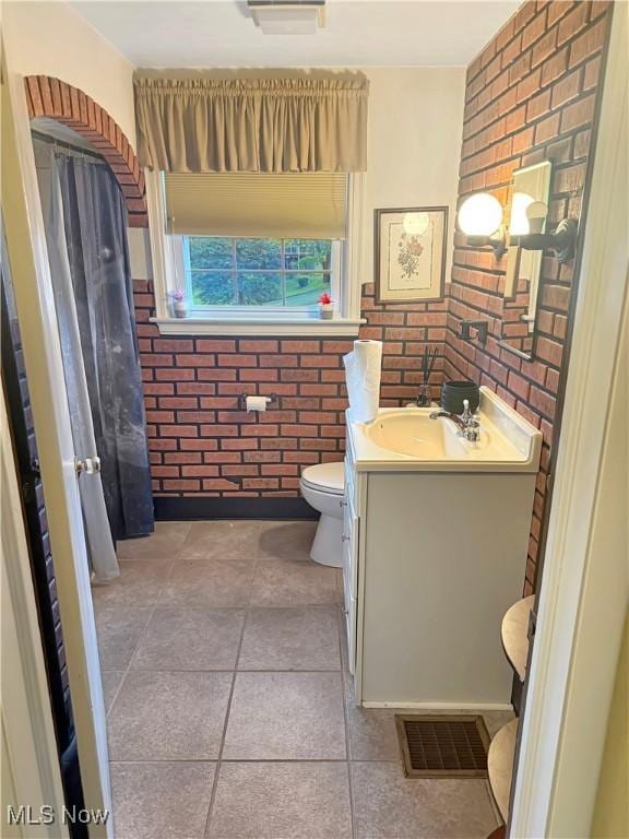 107 Harmon Ave, Weirton, WV 26062 - bathroom featuring vanity, brick wall, and a wainscoted wall