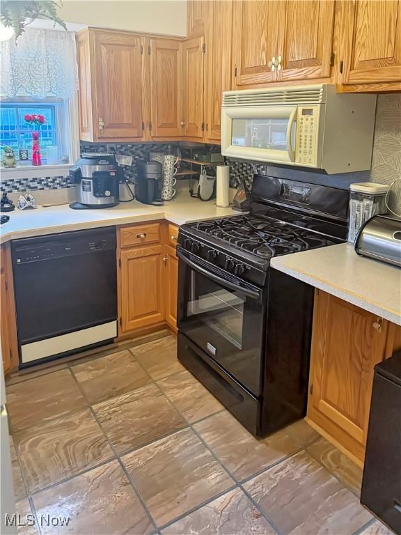 107 Harmon Ave, Weirton, WV 26062 - kitchen featuring black appliances, light countertops, and decorative backsplash