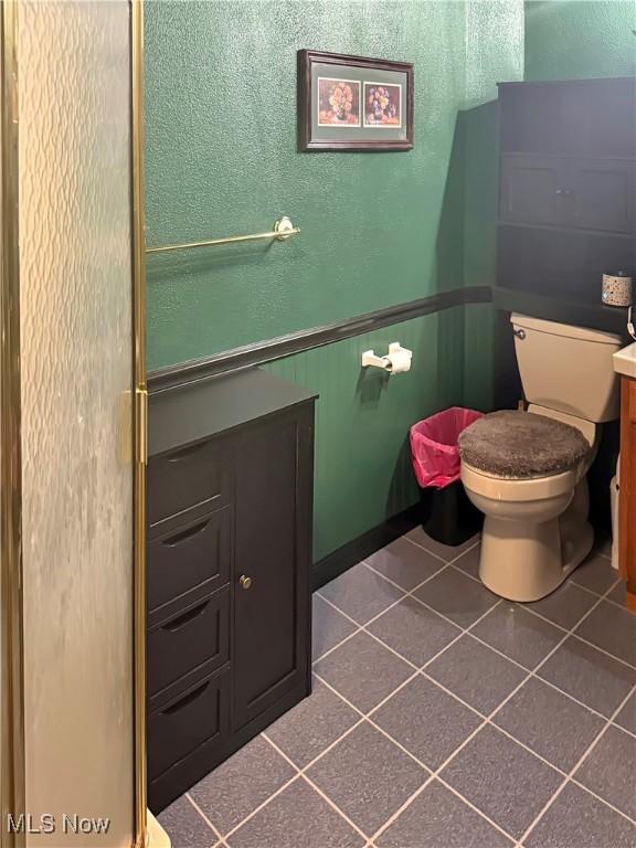 107 Harmon Ave, Weirton, WV 26062 - bathroom with tile patterned floors, vanity, wainscoting, and a textured wall