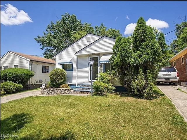 17005 Lipton Ave, Cleveland, OH 44128 - view of front of house with concrete driveway and a front yard