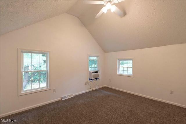 1022 Big Falls Ave, Akron, OH 44310 - spare room featuring lofted ceiling, ceiling fan, dark colored carpet, cooling unit, and a textured ceiling