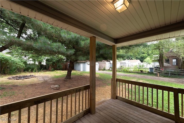 1022 Big Falls Ave, Akron, OH 44310 - wooden terrace with a fenced backyard and a storage unit