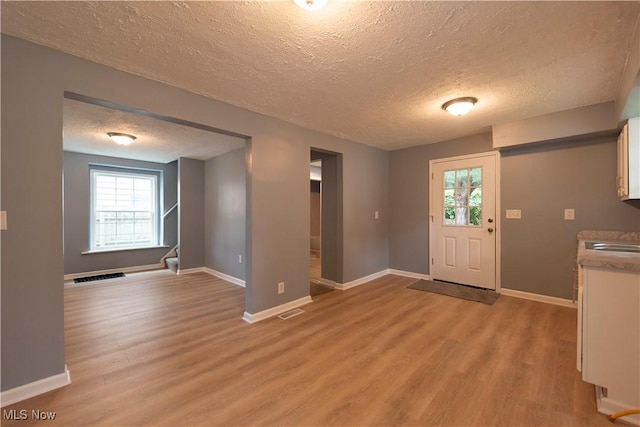 1022 Big Falls Ave, Akron, OH 44310 - entryway with a textured ceiling, light wood finished floors, and plenty of natural light