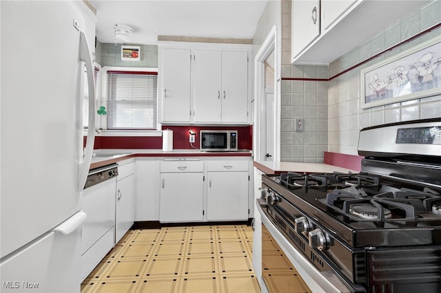 4095 W 161st St, Cleveland, OH 44135 - kitchen with appliances with stainless steel finishes, white cabinetry, tasteful backsplash, light flooring, and light countertops