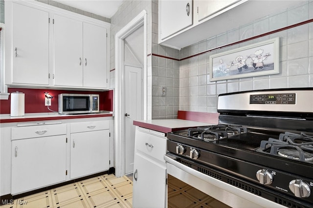 4095 W 161st St, Cleveland, OH 44135 - kitchen featuring appliances with stainless steel finishes, white cabinetry, light countertops, and backsplash