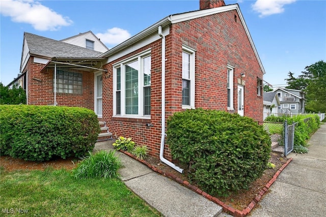 4095 W 161st St, Cleveland, OH 44135 - view of side of home featuring a chimney and brick siding