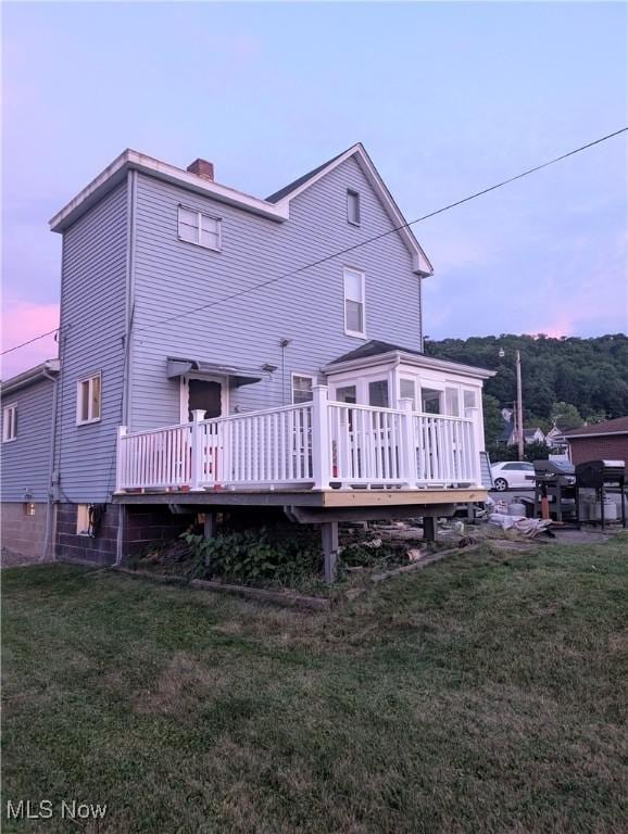 331 Louisiana Ave, Chester, WV 26034 - rear view of house featuring a chimney, a wooden deck, and a yard