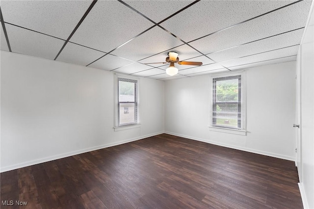 160 State St, Struthers, OH 44471 - empty room with healthy amount of natural light, wood finished floors, and a paneled ceiling