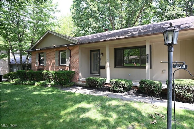 755 Blueberry Hill Dr, Canfield, OH 44406 - ranch-style house with brick siding, a front yard, covered porch, and roof with shingles