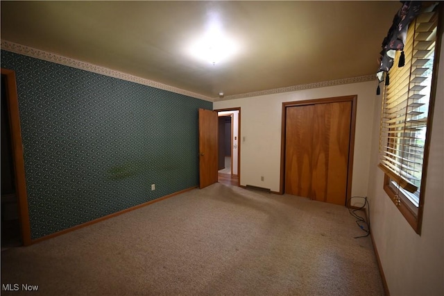 755 Blueberry Hill Dr, Canfield, OH 44406 - unfurnished bedroom with carpet, wallpapered walls, a closet, and ornamental molding