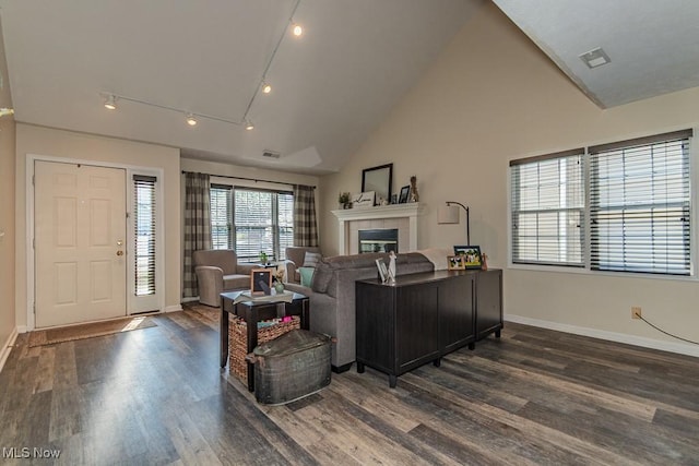 3886 Dugans Lndg, Perry, OH 44081 - living room featuring dark wood-style flooring, a tiled fireplace, lofted ceiling, and track lighting