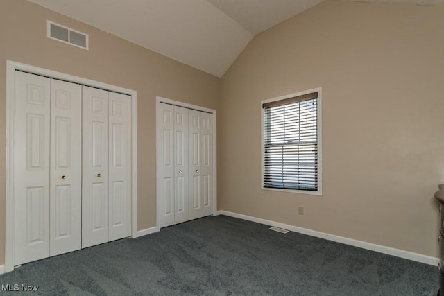 3886 Dugans Lndg, Perry, OH 44081 - unfurnished bedroom featuring multiple closets, dark carpet, and vaulted ceiling