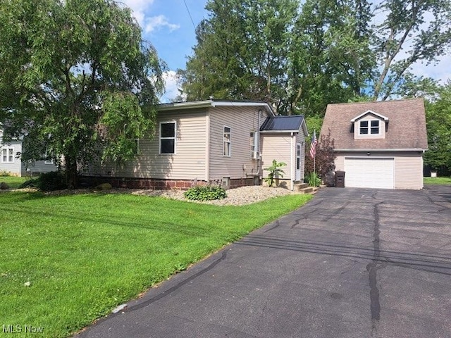 4016 State Route 7, Burghill, OH 44404 - view of front of property featuring driveway, a front lawn, and a garage