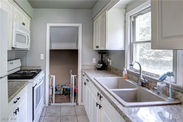 6133 Denison Blvd, Parma Heights, OH 44130 - kitchen featuring white appliances, white cabinets, and light tile patterned flooring