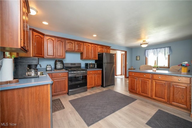 440 Lyons Ave, East Palestine, OH 44413 - kitchen featuring appliances with stainless steel finishes, brown cabinets, light wood-type flooring, and recessed lighting