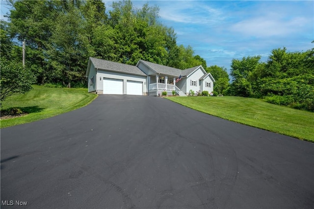 440 Lyons Ave, East Palestine, OH 44413 - ranch-style house featuring a garage, covered porch, a front lawn, and driveway
