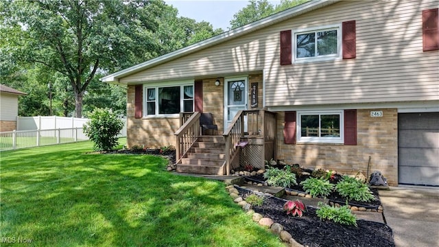 2463 NW Renner Dr NW, Dover, OH 44622 - split level home featuring brick siding, an attached garage, and driveway