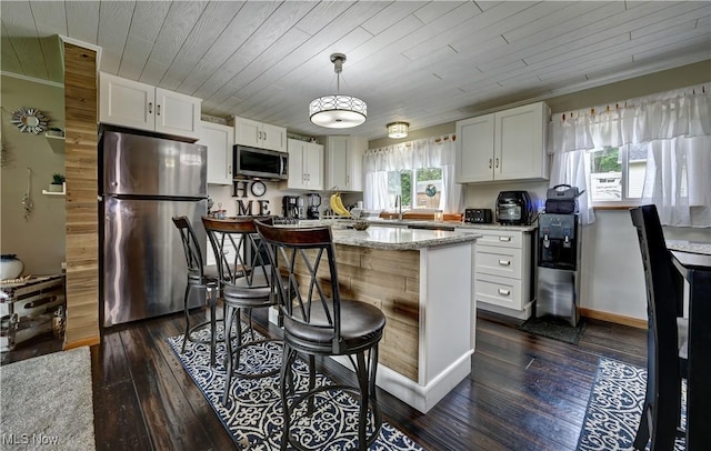 2463 NW Renner Dr NW, Dover, OH 44622 - kitchen with stainless steel appliances, dark wood-type flooring, white cabinetry, light stone counters, and a center island