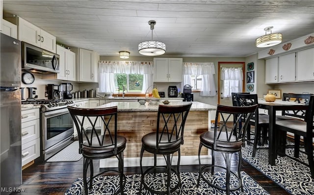2463 NW Renner Dr NW, Dover, OH 44622 - kitchen with appliances with stainless steel finishes, white cabinets, and dark wood finished floors