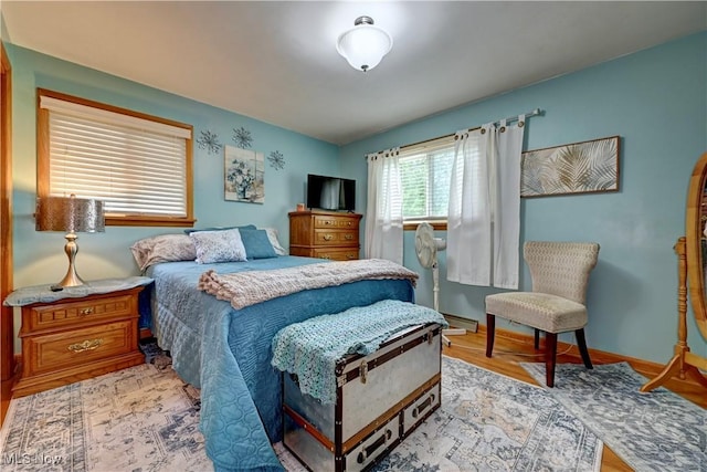 2463 NW Renner Dr NW, Dover, OH 44622 - bedroom with light wood-style floors and a baseboard radiator