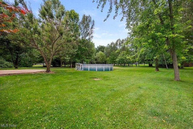 1005 Penn Ct, Grafton, OH 44044 - view of green lawn with a covered pool and view of scattered trees