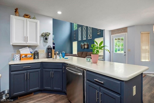 1005 Penn Ct, Grafton, OH 44044 - kitchen with stainless steel dishwasher, blue cabinets, a peninsula, dark wood-type flooring, and white cabinets