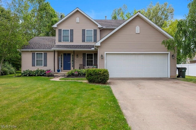1005 Penn Ct, Grafton, OH 44044 - traditional-style house with driveway, a front lawn, covered porch, and a garage