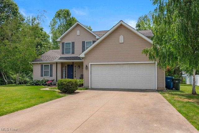1005 Penn Ct, Grafton, OH 44044 - traditional-style house with a front lawn, an attached garage, driveway, and a shingled roof