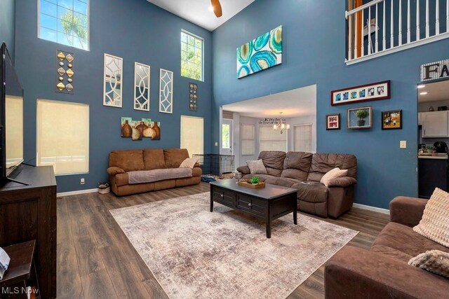 1005 Penn Ct, Grafton, OH 44044 - living area featuring a towering ceiling, wood finished floors, a chandelier, and plenty of natural light