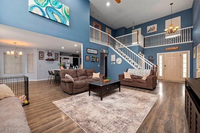 1005 Penn Ct, Grafton, OH 44044 - living room featuring a chandelier, a high ceiling, wood finished floors, and stairs