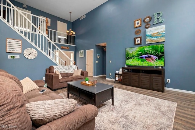 1005 Penn Ct, Grafton, OH 44044 - living area with stairway, wood finished floors, a high ceiling, and a chandelier