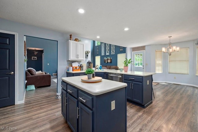 1005 Penn Ct, Grafton, OH 44044 - kitchen featuring blue cabinets, light countertops, a peninsula, a chandelier, and a center island