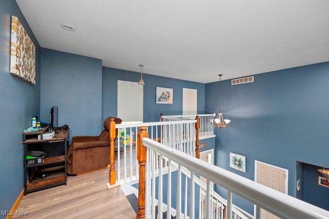 1005 Penn Ct, Grafton, OH 44044 - hall with an upstairs landing, wood finished floors, and a chandelier