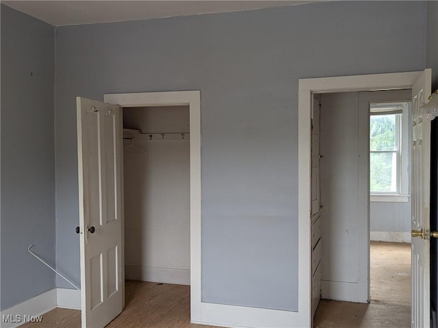 318 S Canal St, Canal Fulton, OH 44614 - unfurnished bedroom with wood finished floors and a closet