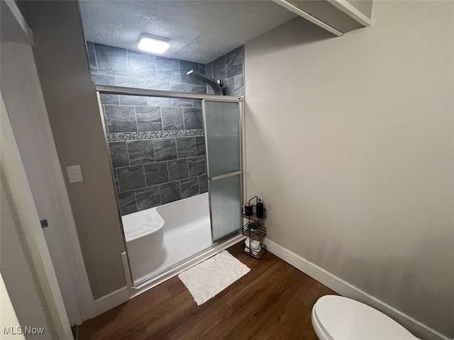 3402 Easton Rd, Norton, OH 44203 - bathroom featuring a shower stall, wood finished floors, and a textured ceiling