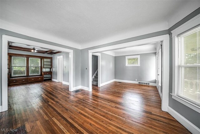 9907 Kempton Ave, Cleveland, OH 44108 - unfurnished room featuring wood-type flooring, stairs, a textured ceiling, and a ceiling fan