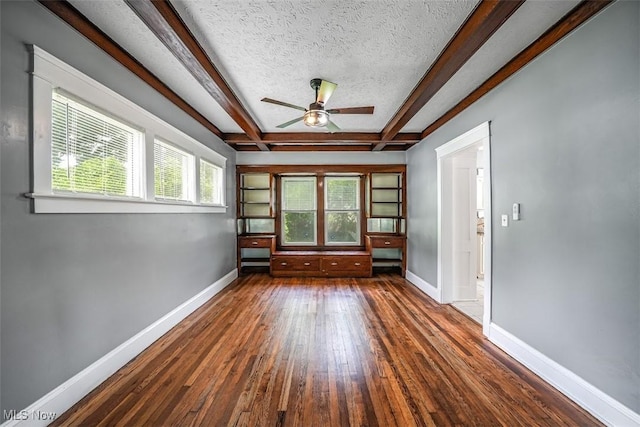9907 Kempton Ave, Cleveland, OH 44108 - unfurnished room featuring wood-type flooring, ceiling fan, beamed ceiling, and a textured ceiling