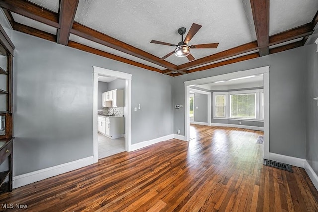 9907 Kempton Ave, Cleveland, OH 44108 - unfurnished living room with coffered ceiling, hardwood / wood-style flooring, ceiling fan, and beam ceiling
