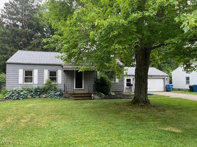 5559 Fitch Rd, North Olmsted, OH 44070 - view of front of home featuring concrete driveway, a front yard, and a garage